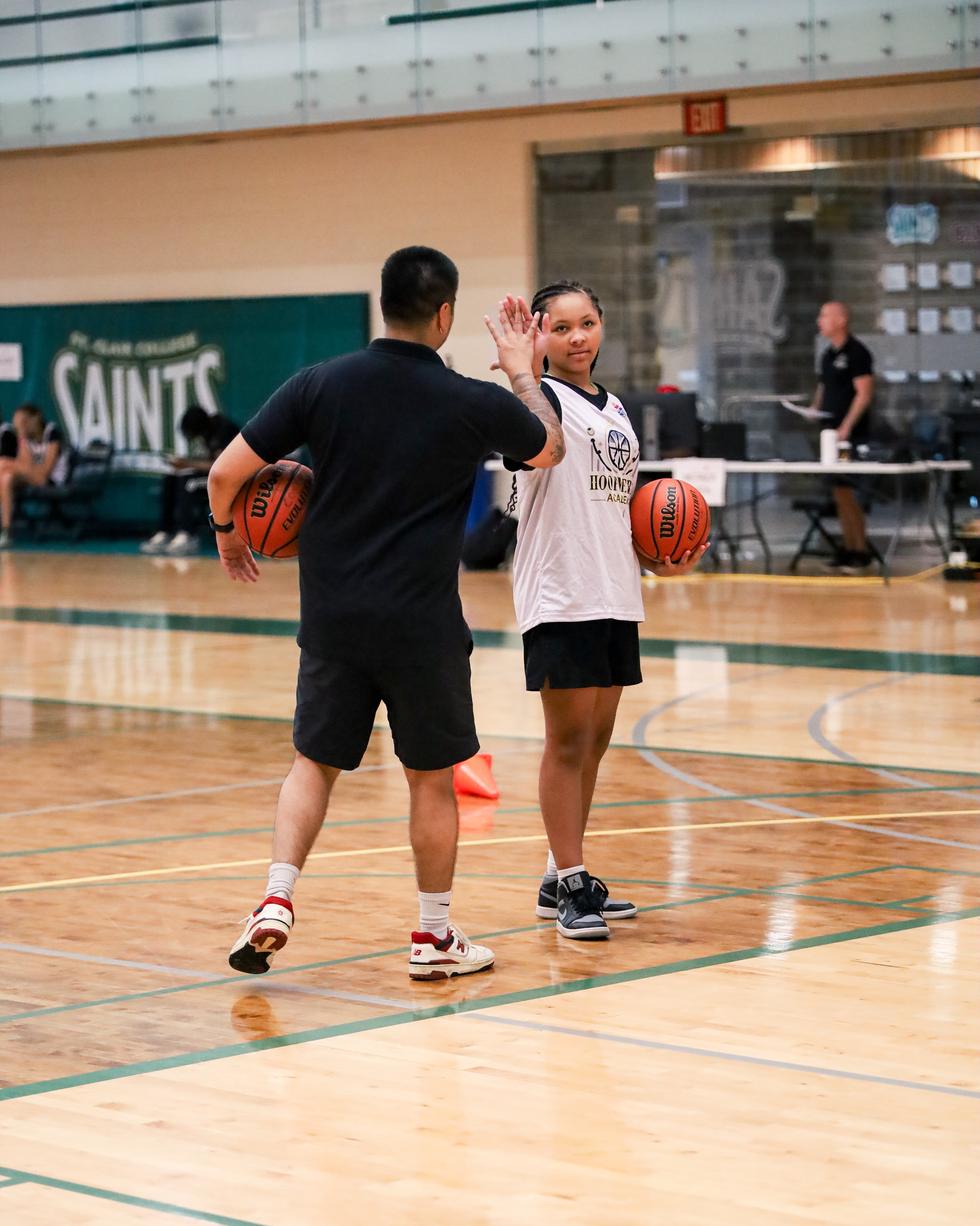 A Hoop Metric coach encouraging a young athlete during training